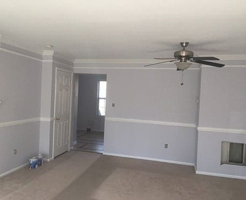 Empty  room with ceiling fan. Freshley painted with light gray paint, white trim and white ceiling.
