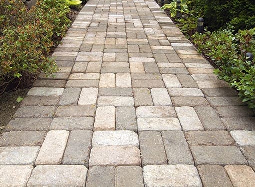 gray stone walkway with pavers laid in a grid/basketweave pattern