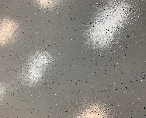 close up image of gray epoxy floor with white and black specs